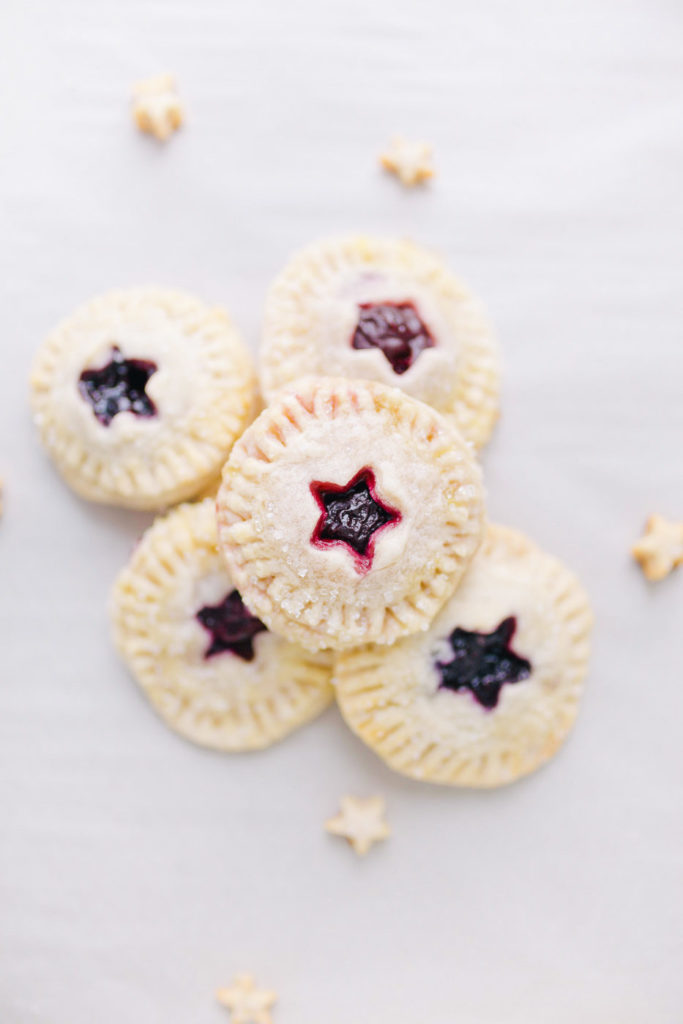 A simple and delicious homemade cherry and blueberry hand pie recipe by Lauren Cermak of Going For Grace. This recipe is the perfect addition to any meal!