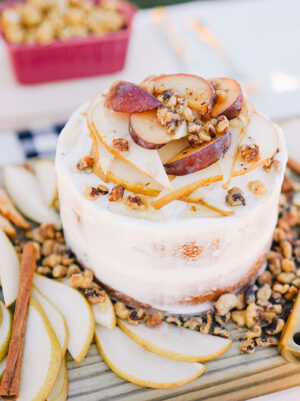classic spice cake with cream cheese frosting topped with plums and pears