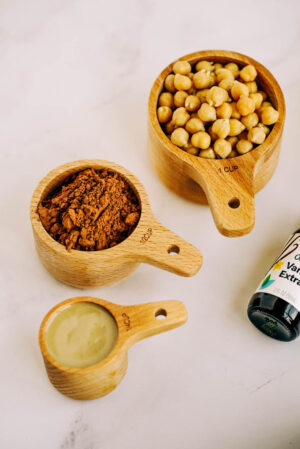 Dark chocolate hummus ingredients on white marble counter.