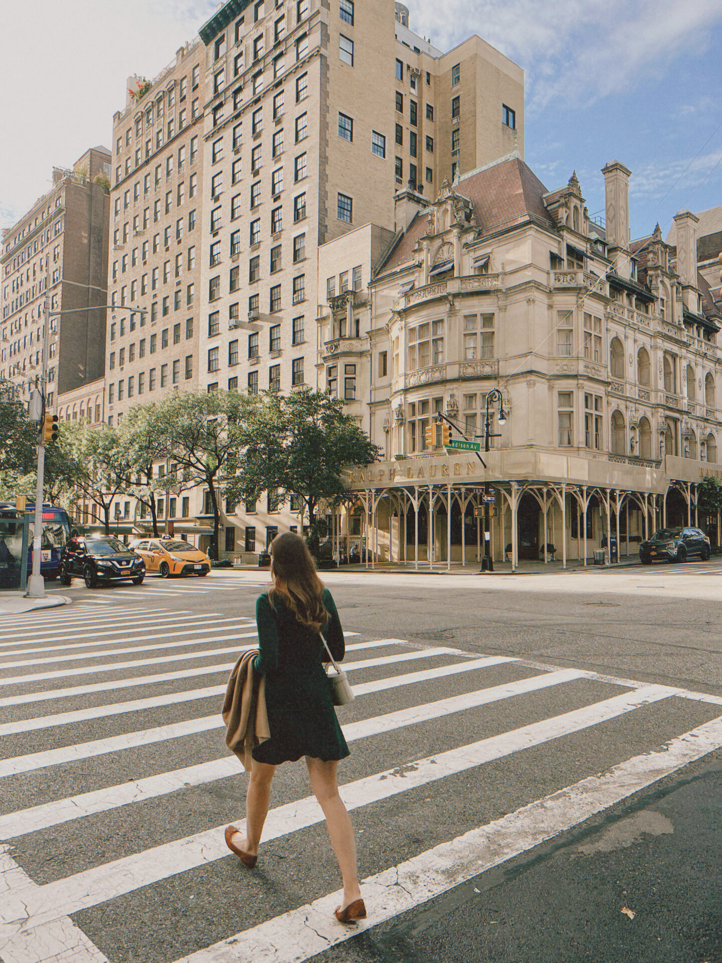 Woman crossing the street on Madison Avenue in New York City.